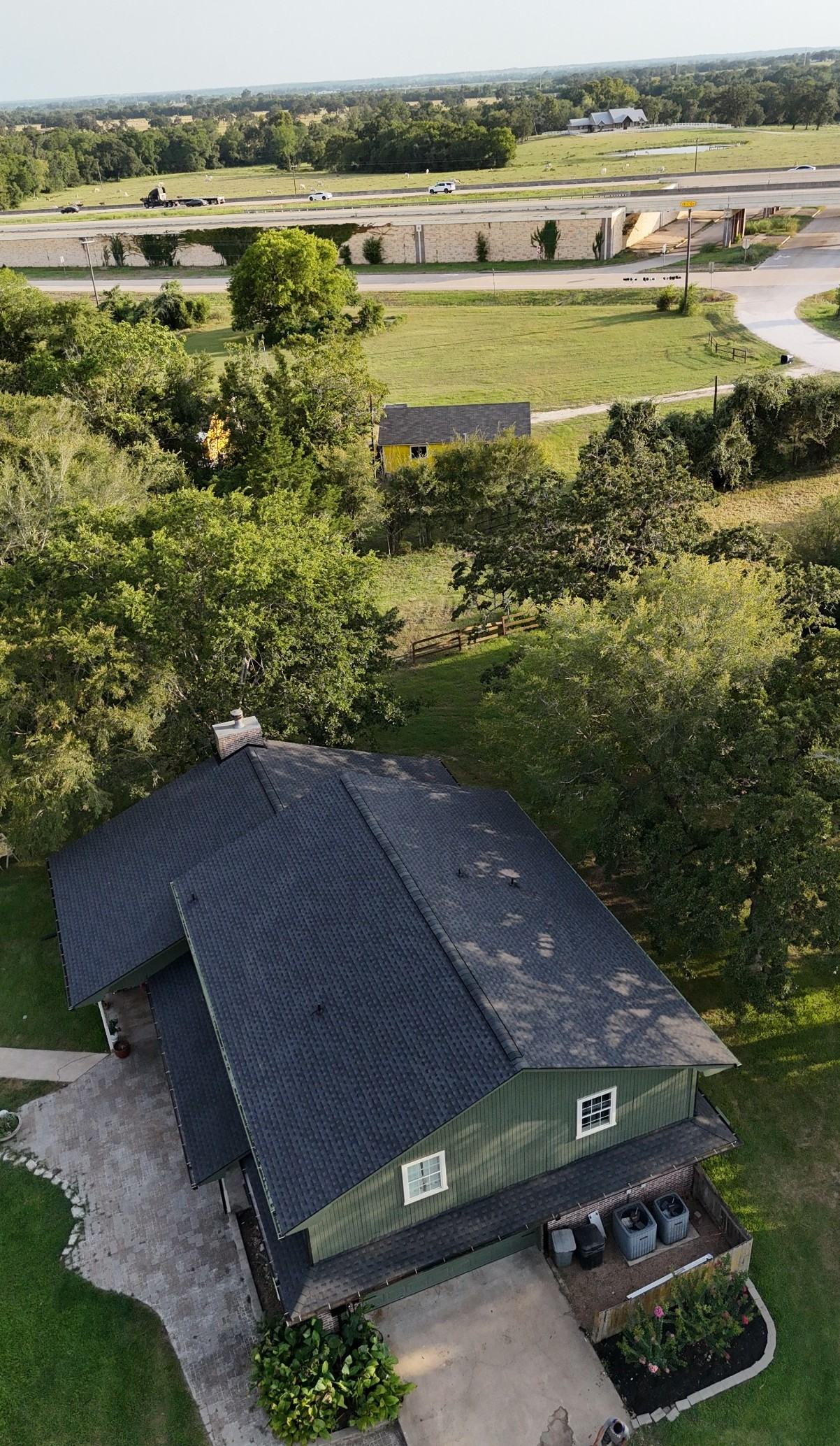Close aerial detail of hip roof shingle installation